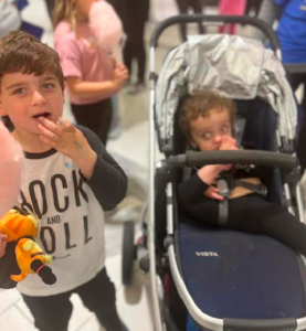 Noah with cotton candy and Hailey sitting in stroller